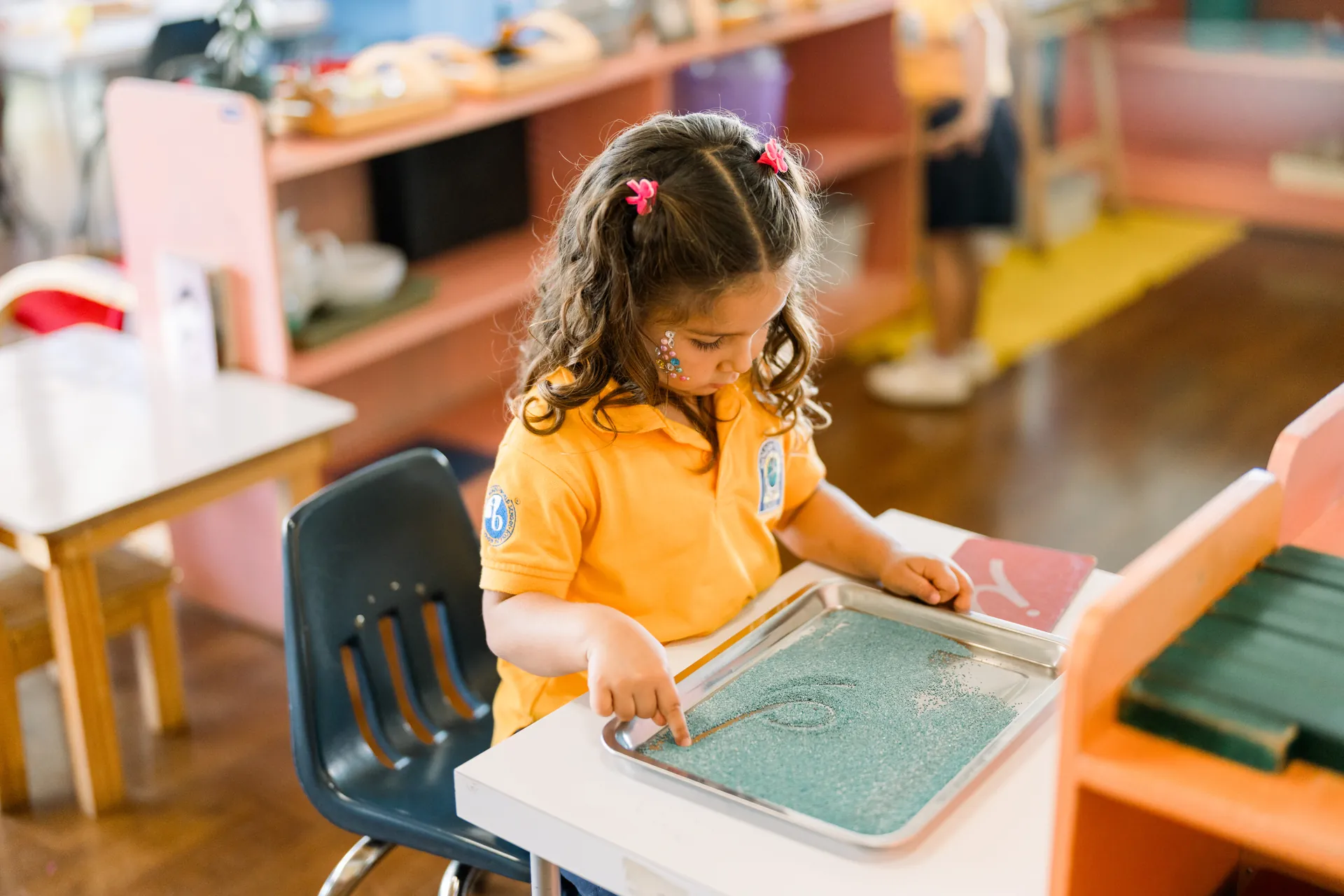 Child in deep concentration during the Montessori work cycle